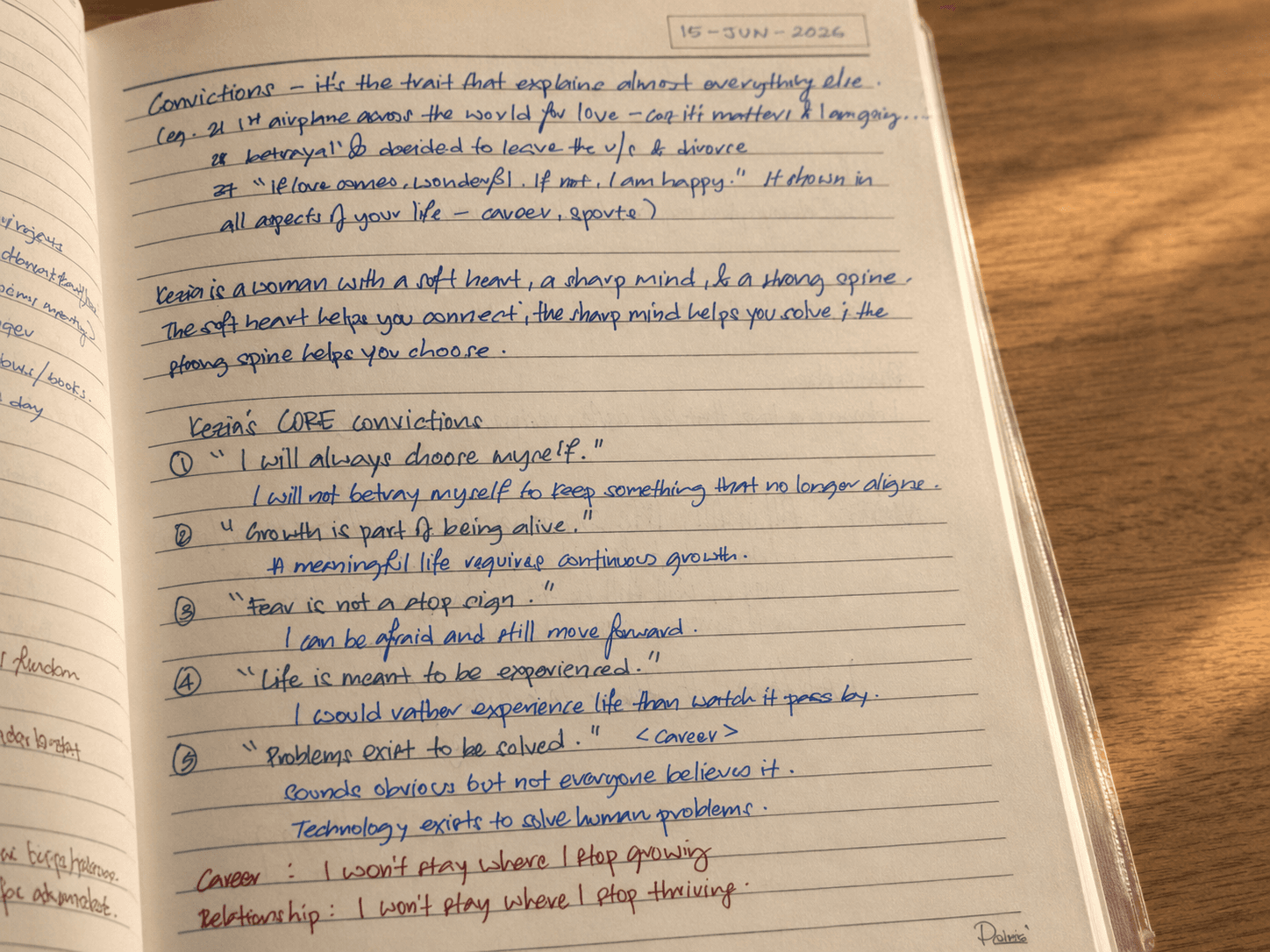 Close-up of a handwritten journal page, warm light